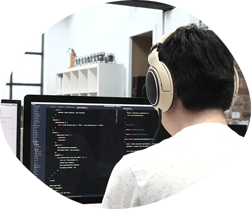 Developer coding with headphones on