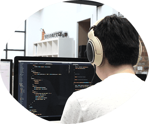 Developer coding with headphones on