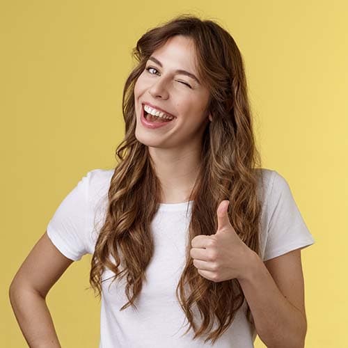 Woman winking and giving thumbs up