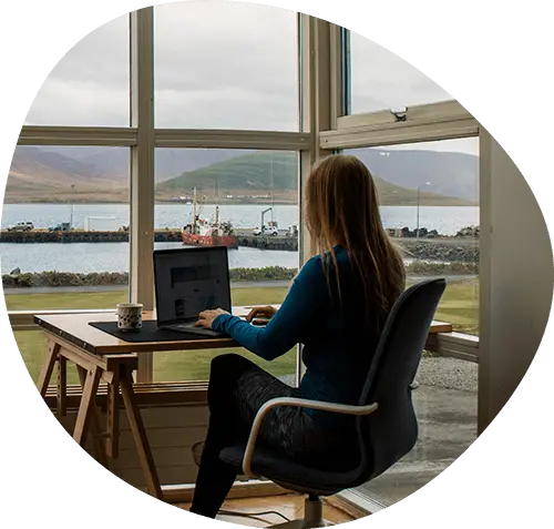 Woman on her laptop with a beautiful view